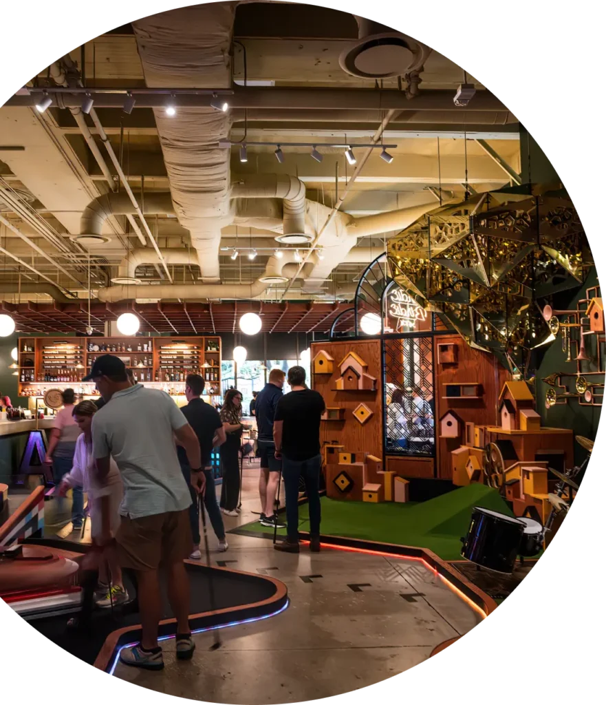 Photo of Dirdie Birdie's Austin-themed indoor mini golf course in a circular frame.